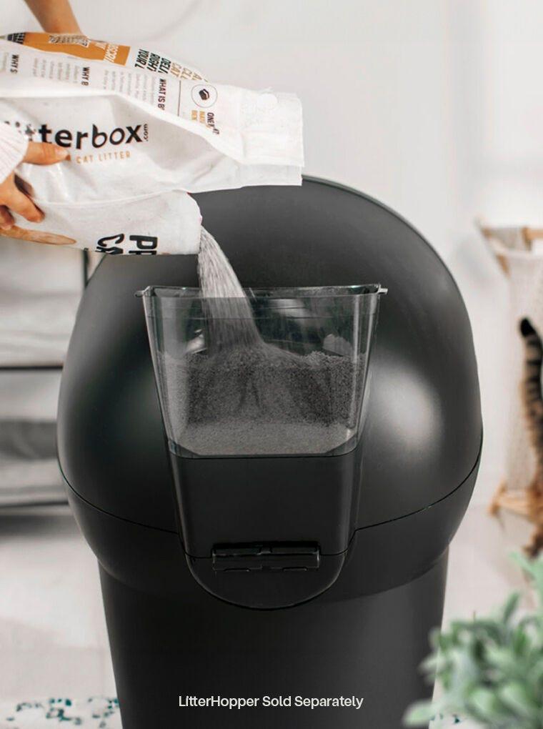 Litter-Robot 4 self-cleaning litter box with LitterHopper accessory being refilled at the back of the unit